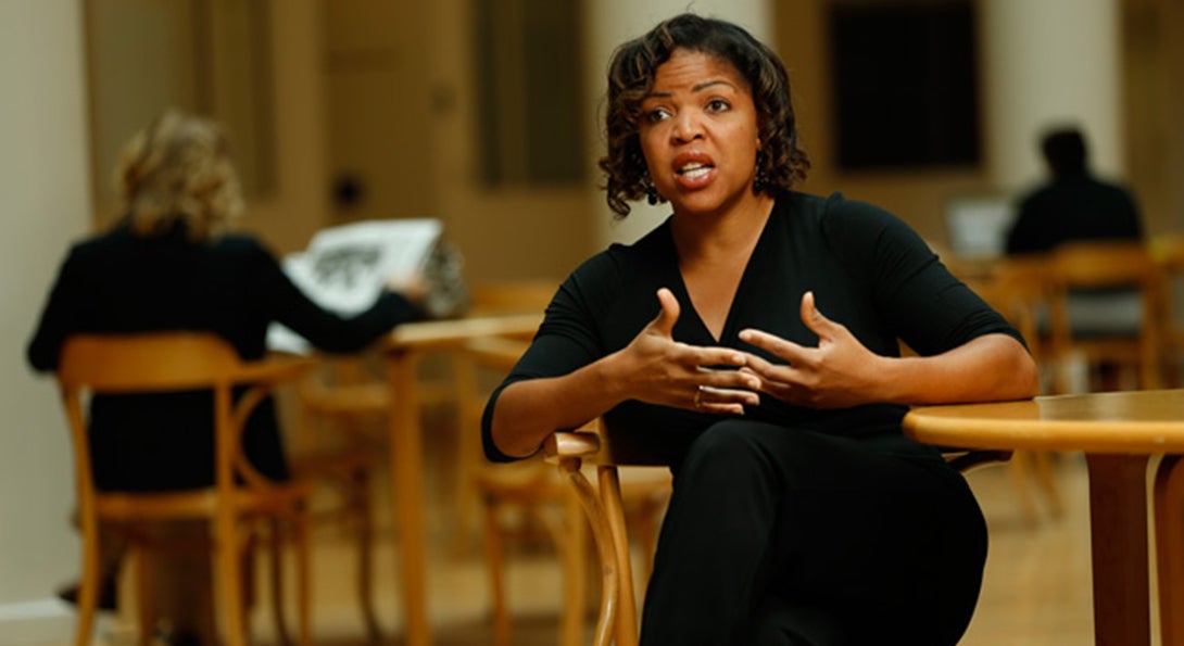 Ebony McGee sits at a table in the library at Vanderbilt University engaged in an interview with an interviewer who is unseen in the photo.