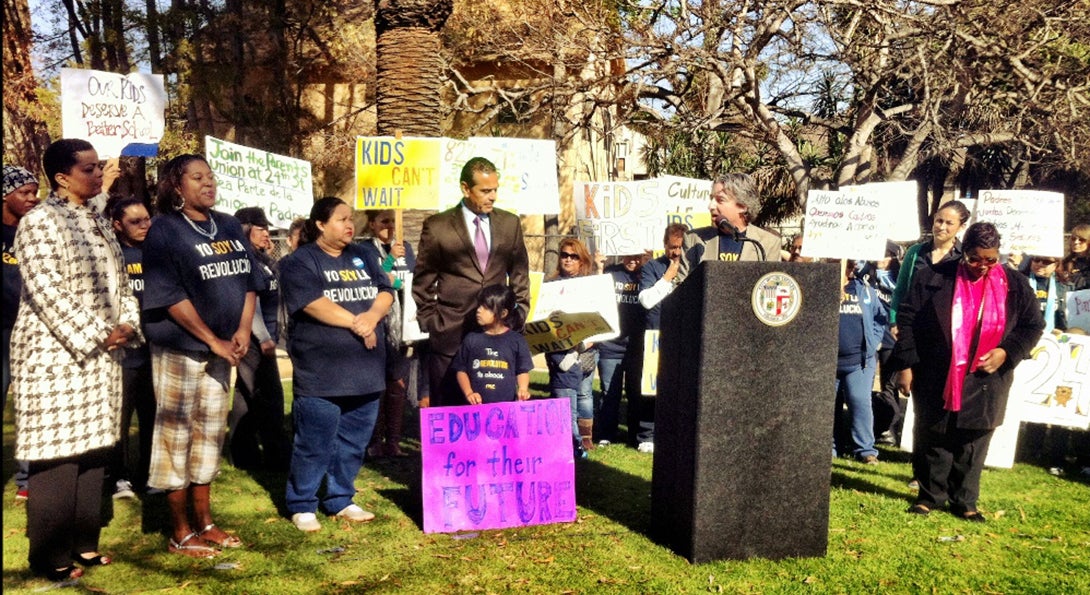 Parents and Los Angeles city leaders speak at a rally supporting a new hybrid charter and public school.