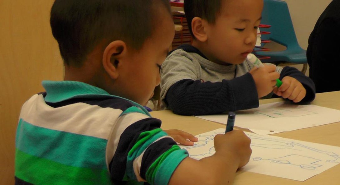 Two students work on a drawing at the Chinese American Service League early childhood center.