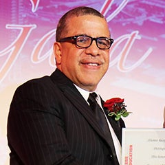 Ernesto Matias accepts his award from Dean Alfred Tatum and poses for a picture while doing so at the 2017 Alumni Honors Gala.