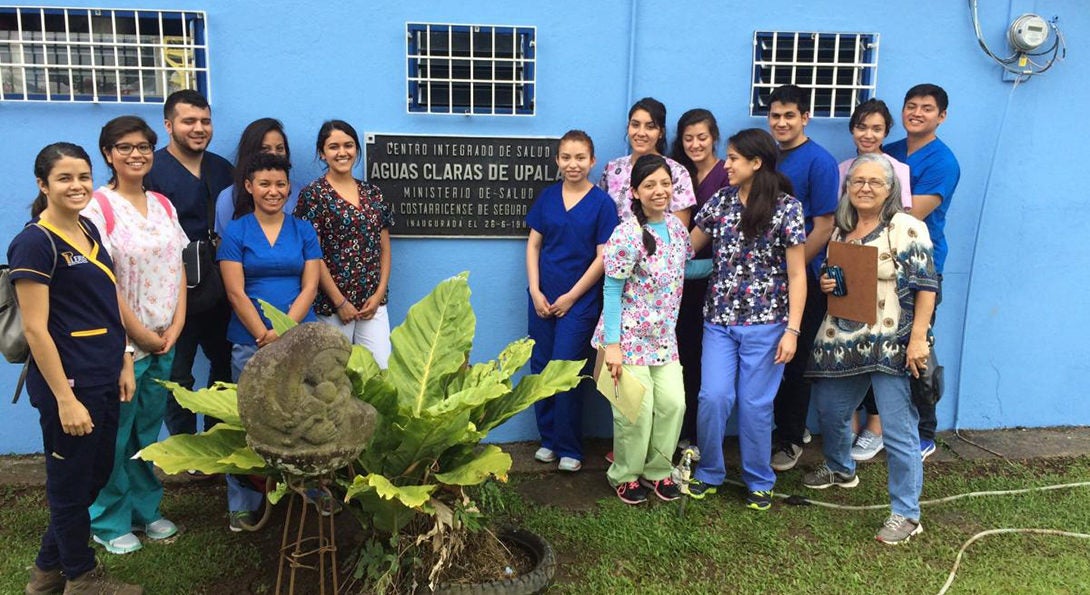 Alumna Daisy Zamora poses for a photo with fellow health care workers outside a Ministry of Health building in Costa Rica.