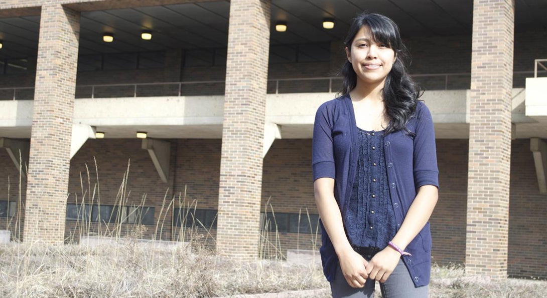 Evelyn Gachuz poses for a photograph standing outside the College of Education building on UIC's campus.
                  