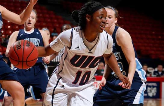 UIC women's basketball player Terri Bender dribbles around an Elmhurst College defender in a game at the UIC Pavilion.