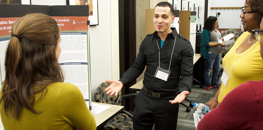 Master Teaching Fellow Jorge Santana engages SEEEC teaching fellows in conversation on his poster presentation.
