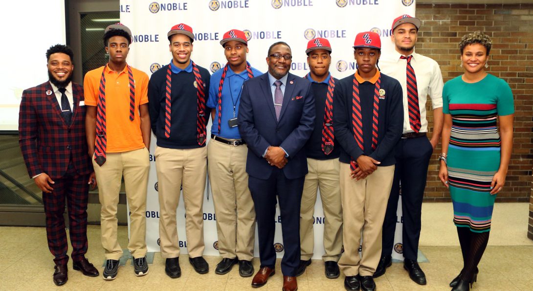 Dean Tatum stands in the middle of the Call Me MiSTER scholarship winners as well as principal Charles Goins and Noble Network CEO Constance Jones