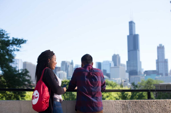 Students on UIC campus looking at Chicago skyline